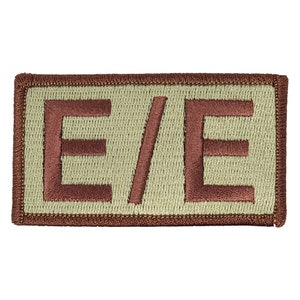 May include: A brown embroidered patch with the text "E/E" in white on a beige background.