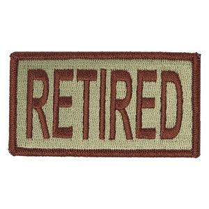 May include: A brown embroidered patch with a beige background that says "RETIRED" in brown lettering.