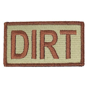 May include: A tan embroidered patch with a brown border. The patch says "DIRT" in brown letters.
