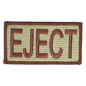 May include: A brown embroidered patch with the word "EJECT" in white lettering.