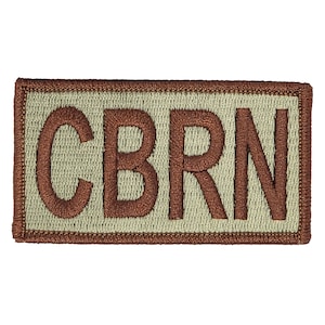 Może przedstawiać: Brązowa naszywka haftowana z literami CBRN na jasnozielonym tle.