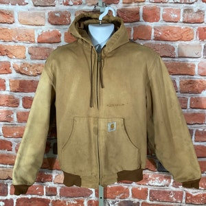 May include: A brown hooded work jacket with a zipper closure and a Carhartt logo patch on the chest. The jacket has a brown ribbed knit collar, cuffs, and waistband.