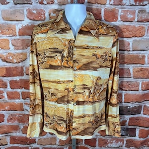 May include: A button-down shirt with a Western-themed print. The shirt features a landscape design with horses and riders in shades of brown, tan, and cream. The long-sleeved shirt is displayed on a mannequin.