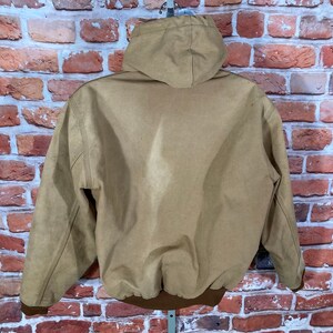 May include: A brown hooded jacket with a zipper closure. The jacket has a brown ribbed knit waistband and cuffs.