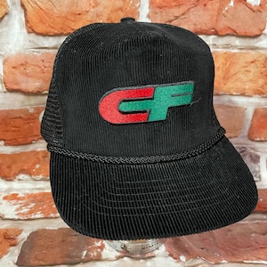 May include: Black corduroy trucker hat with a red and green "CF" logo.