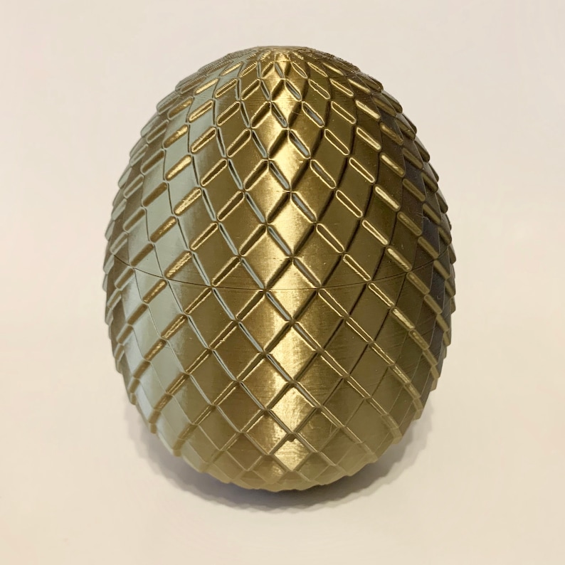 May include: A gold dragon egg-shaped decorative object with a textured surface.