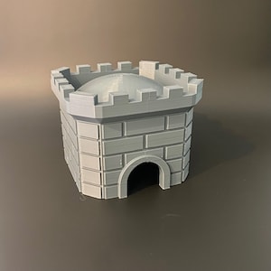 May include: A gray 3D printed castle tower with a crenellated top and a small entrance.