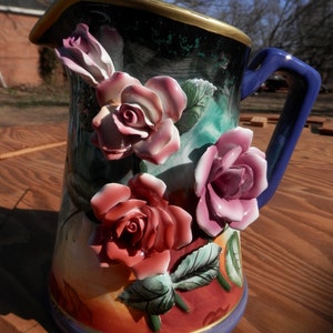 Majolica Type Finish Water Picture with Applied Ceramic Flowers and Gold Rimmed