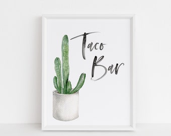 Może przedstawiać: Biały wydruk w ramie z akwarelową ilustracją kaktusa w białej doniczce. Tekst "Taco Bar" jest napisany czarną kaligrafią.