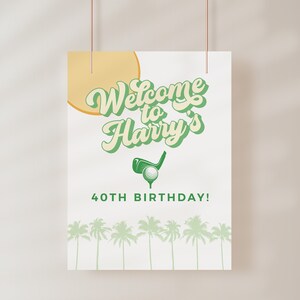 May include: A white welcome sign with green text that says "Welcome to Harry's 40th Birthday!"  The sign has a green golf club and golf ball graphic and a yellow sun graphic.