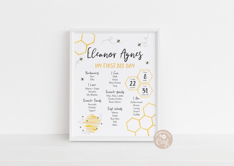 May include: A white framed printable poster with a yellow honeycomb pattern and a bee theme. The poster is titled "Eleanor Agnes My First Bee Day" and includes details about the baby's first year, such as nicknames, favorite foods, first words, and personality traits.