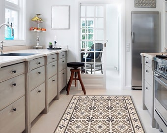 May include: A kitchen with white cabinets and a patterned rug. The rug has a beige background with brown and black geometric designs.