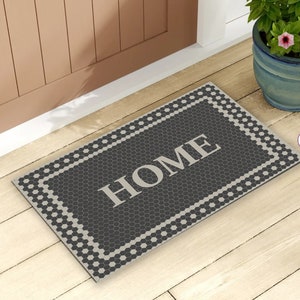 May include: Black and white doormat with a honeycomb pattern and the word "HOME" in white lettering.