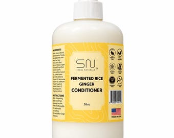 May include: A white plastic bottle with a pump dispenser containing 16oz of Seoul Naturals Fermented Rice Ginger Conditioner. The yellow label features the product name, ingredient list, usage instructions, a barcode, and icons for cruelty-free, vegan, sulfate-free, silicone-free, paraben-free, and phthalate-free status, plus a small American flag.