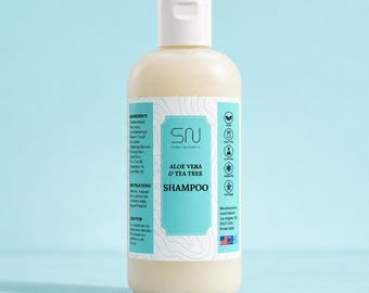 May include: A clear plastic bottle of Seoul Naturals Aloe Vera & Tea Tree shampoo with a white cap. The label features light blue accents, a list of ingredients, instructions, and icons indicating vegan, cruelty-free, and gluten-free certifications.