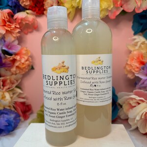 May include: Two clear plastic bottles of Bedlington Supplies fermented rice water shampoo infused with raw ginger. The smaller bottle is 8 fl oz and the larger bottle is 16 fl oz. Both feature white labels with black text and a ginger root graphic.