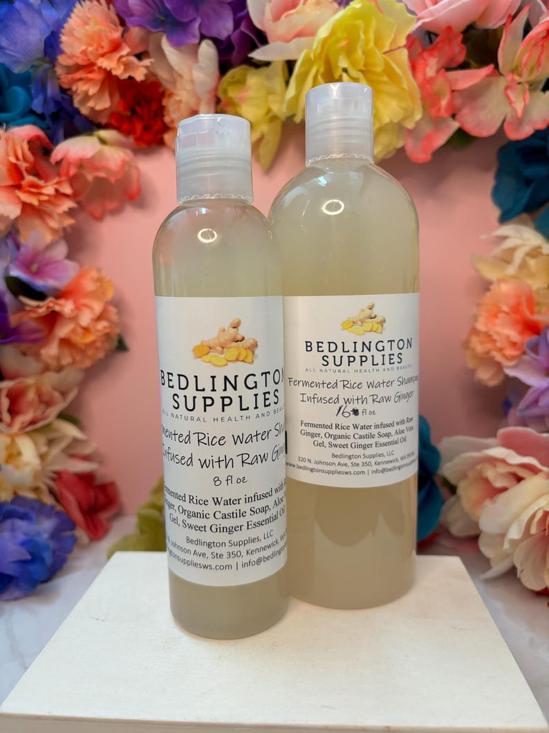 May include: Two clear plastic bottles of Bedlington Supplies fermented rice water shampoo infused with raw ginger. The smaller bottle is 8 fl oz and the larger bottle is 16 fl oz. Both feature white labels with black text and a ginger root graphic.