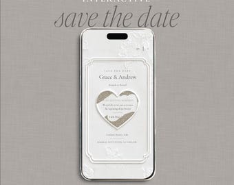 May include: A smartphone screen displaying an interactive digital save the date invitation. The white interface features the text Grace & Andrew, a heart-shaped scratch-to-reveal element, and event details including the date 14th May 202X and location.