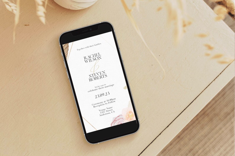 May include: A wedding invitation on a smartphone with a gold and white design. The invitation reads "Rachel Wilson & Steven Roberts" and includes the date "23.09.23".