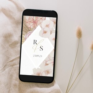 May include: A smartphone displaying a wedding invitation with a floral design and the initials "R & S" in gold script. The date "23.09.23" is also displayed on the screen.