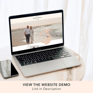 May include: A laptop computer displaying a wedding website with a couple walking on a beach. The website features a map with a heart icon marking their location. The text on the website reads "Rachel & Steven" and "Our Happy Day".
