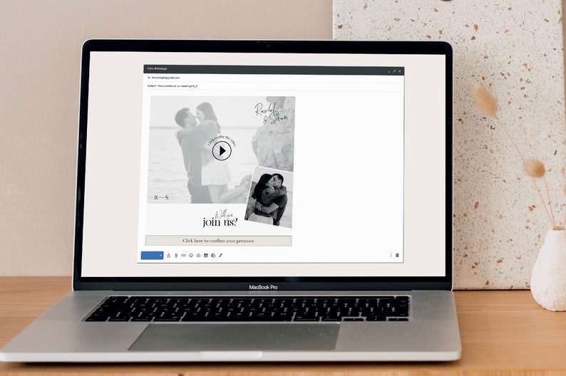 May include: A laptop screen displaying a wedding invitation with a black and white photo of a couple and a play button. The text on the invitation reads "Will you join us?" and "Click here to confirm your presence".