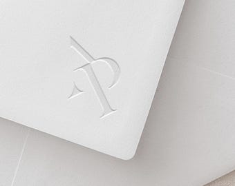 May include: A white envelope with a raised, embossed logo of the letters "AP" in a stylized font.