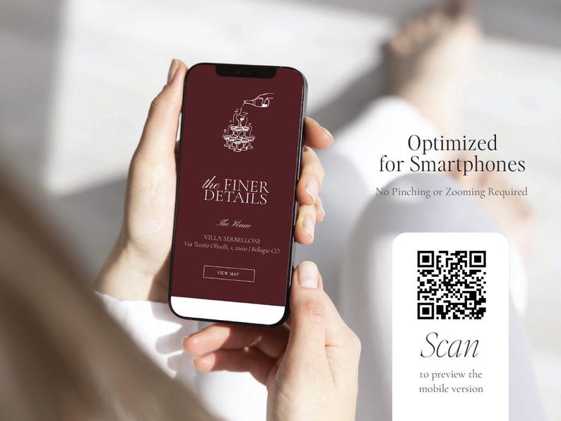 May include: A smartphone displaying a maroon screen with white text and graphics. The screen reads "the FINER DETAILS" and includes a QR code for scanning. The phone is held in a person's hands.