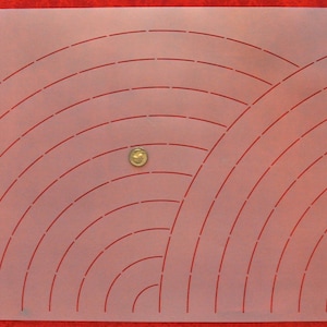May include: A white plastic quilting template with red lines forming a pattern of overlapping arcs. The template is designed for use with a rotary cutter.