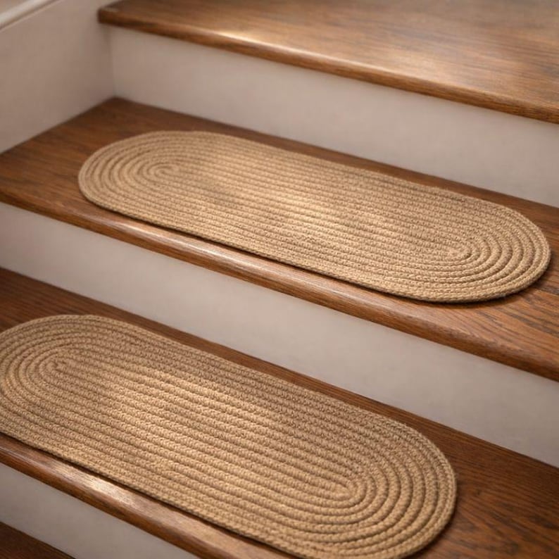 Partial staircase with oval jute stair treads installed, hand crocheted natural stair tread carpet