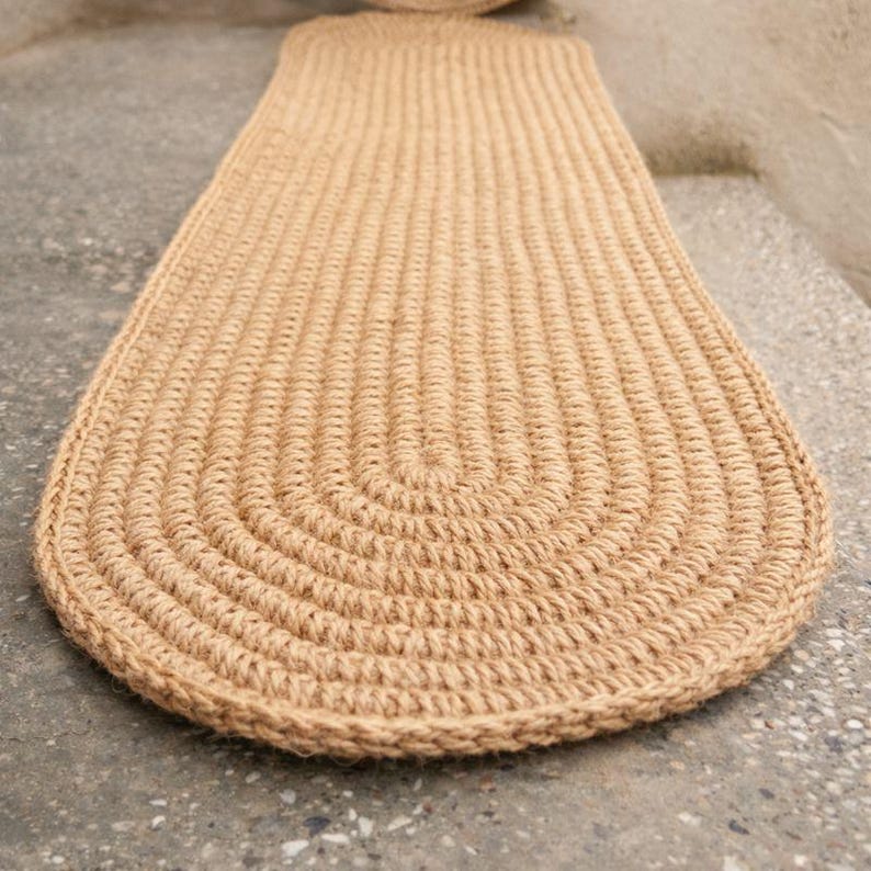 Styled close up of oval jute stair tread with soft light, natural textured stair tread rug detail