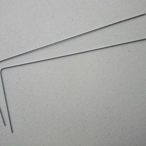May include: Two silver-colored metal bent wire pieces, each with a 90-degree angle.