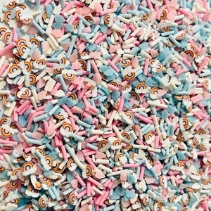 May include: A mix of pastel blue, pink, and white sprinkles with rainbow and cloud shapes.