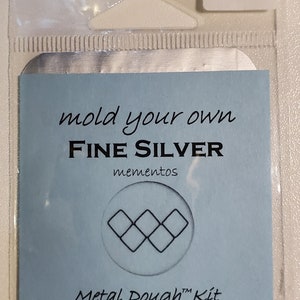 May include: A blue and white card with the text "mold your own FINE SILVER mementos Metal Dough™ Kit free firing 5 ArtWabiSabi.com 262-960-3000".