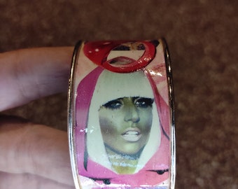 Coppery brass cuff bracelet paper collage portrait singer Lady Gaga vintage on pink background and "POPSTAR" jewelry