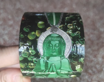 Cardboard cuff bracelet collage paper cut with jade buddha statue on pepper seeds background and "MEDITATION" jewelry