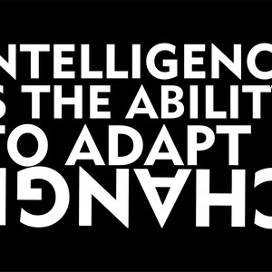 May include: A black background with white text that reads: "INTELLIGENCE IS THE ABILITY TO ADAPT TO CHANGE."