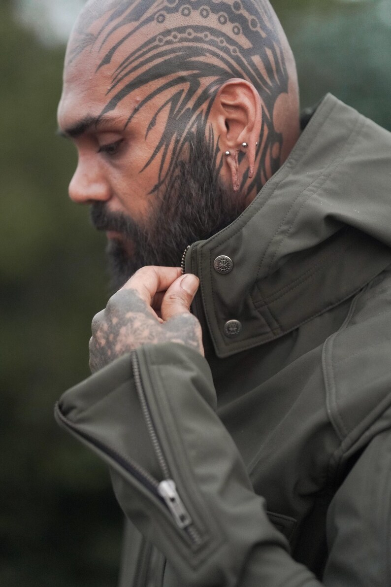 Close-up of men’s olive green GORE-TEX jacket showing collar design and zip detail.