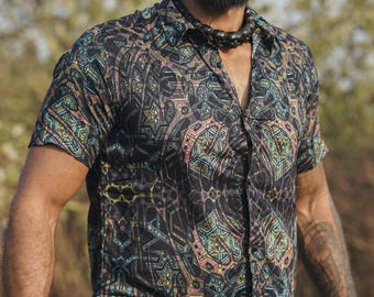 May include: A black short-sleeved button-down shirt with a colorful geometric pattern. The shirt has a collar and a button closure.