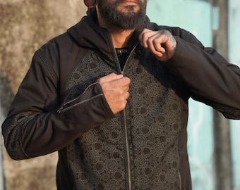 May include: A black hooded jacket with a geometric pattern on the front. The jacket has a zipper closure and a hood.