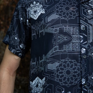 Puede incluir: Una camisa negra de botones con un patrón geométrico blanco de placas de circuito y formas abstractas. El patrón incluye números y símbolos.