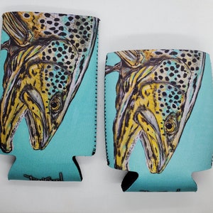 May include: Two turquoise blue neoprene can coolers with a brown trout fish design. The fish is facing upwards with its mouth open. The fish has brown and yellow spots.