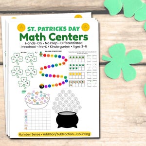 May include: A stack of St. Patrick's Day Math Centers worksheets with shamrock and pot of gold illustrations. The worksheets include counting, addition, and subtraction activities for preschool and kindergarten aged children. Green shamrock cutouts are scattered around the worksheets.
