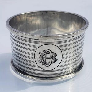 Könnte beinhalten: Ein Set aus drei Keramikbechern mit gesprenkelter, matter Oberfläche. Die Becher sind in Creme-, Hellgrau- und Dunkelgrautönen gehalten. Jeder Becher hat ein schlichtes, minimalistisches Design.