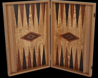 May include: A wooden backgammon board with a diamond inlay in the center of each side. The board is closed and the two halves are open to reveal the playing surface.