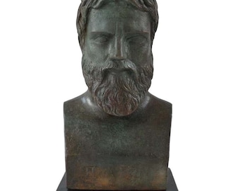 May include: Bronze bust sculpture of a bearded man with a serious expression. The bust is on a black marble base.