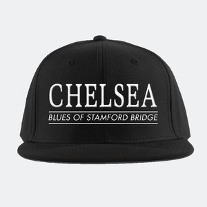 May include: Black baseball cap with white embroidered text that reads "Chelsea Blues of Stamford Bridge".