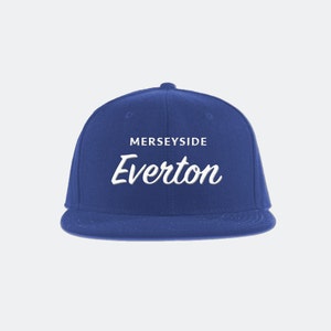 May include: A royal blue baseball cap with a white embroidered logo that says "Merseyside Everton".