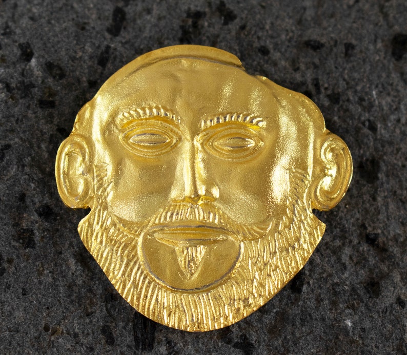 Handcrafted gold plated 925 sterling silver versatile jewel depicting the Mycenaean mask of Agamemnon.Museum copy.It can be worn either as a pendant or as a brooch.Its length is 4cm,its width is 4cm and weighs approx. 13g.