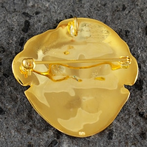 Handcrafted gold plated 925 sterling silver versatile jewel depicting the Mycenaean mask of Agamemnon,the reverse.Museum copy.It can be worn either as a pendant or as a brooch.Its length is 4cm,its width is 4cm and weighs approx. 13g.